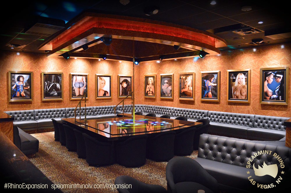 Interior view of a Las Vegas strip club highlighting vibrant lighting, crowd movement, and upscale entertainment design.